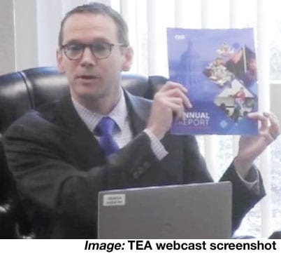 Photo of Education Commissioner Mike Morath holding up TEA 2023 Annual Report during State Board of Education Meeting