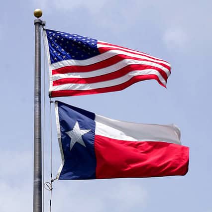 Photo of U.S. Flag and Texas Flag on same flagpole.
