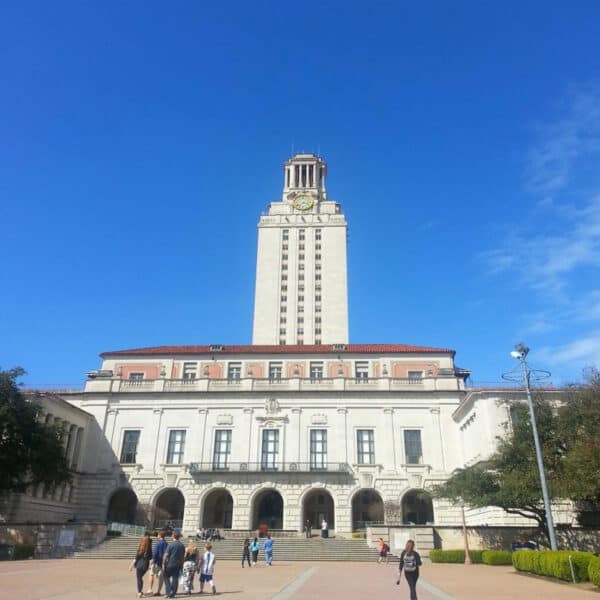Photo: Exterior of UT Administration Building (Tower), with students milling in front.