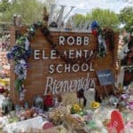 image: Robb Elementary sign, with flowers