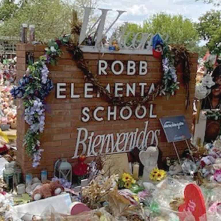 image: Robb Elementary sign, with flowers