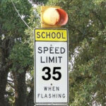 School zone sign, with flashing light